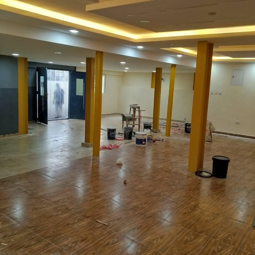 Recreational space revamp with tiled floor, columns and recessed lighting